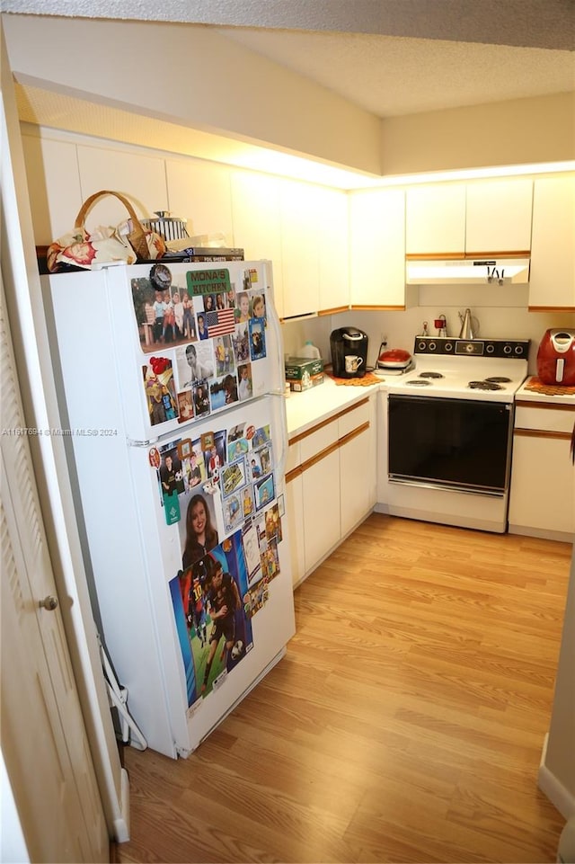 kitchen with white cabinetry, white appliances, and light wood-type flooring