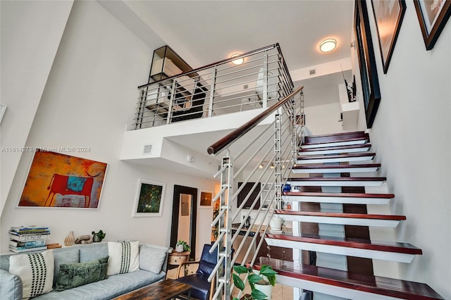 staircase with a towering ceiling