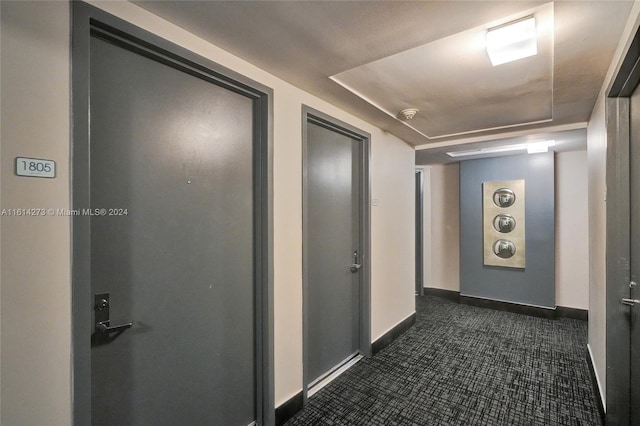 hall featuring dark tile patterned floors