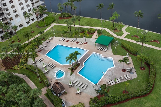 view of swimming pool featuring a patio area and a water view