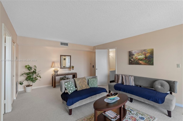 living room with light colored carpet and a textured ceiling