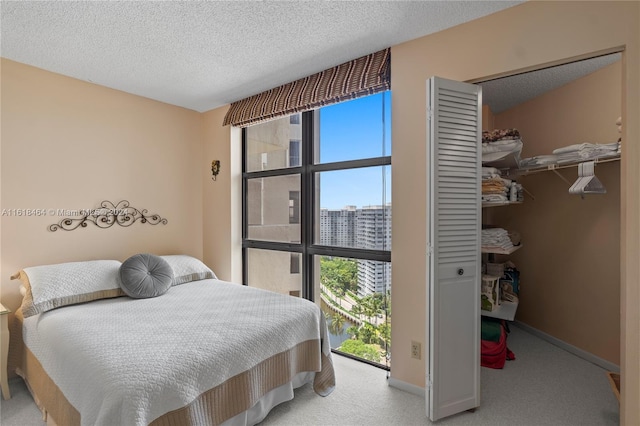 bedroom featuring light carpet, a closet, and a textured ceiling