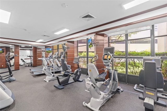 workout area featuring ornamental molding