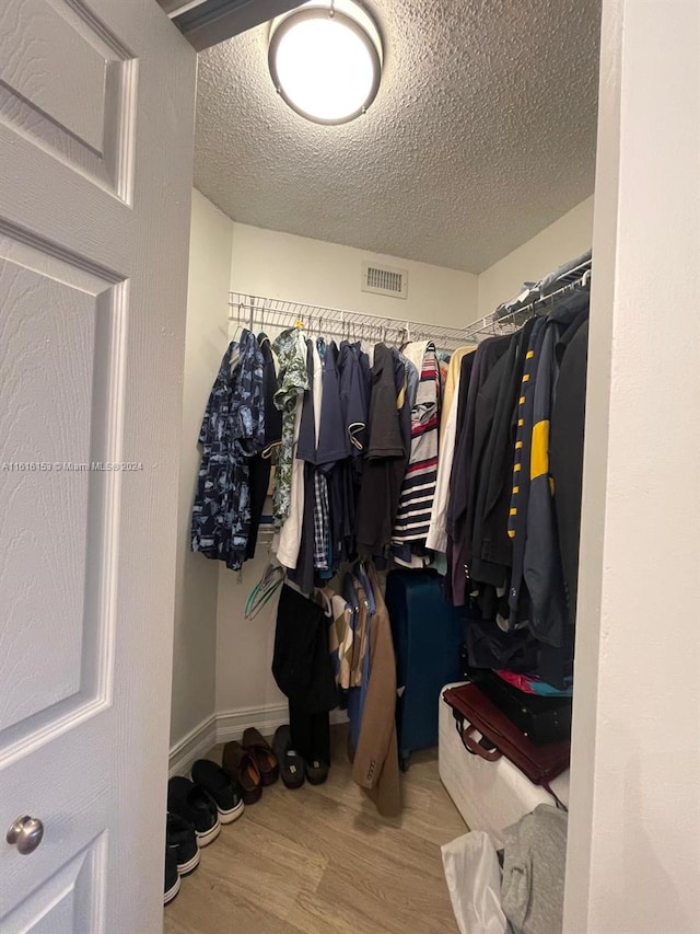 walk in closet featuring light hardwood / wood-style flooring