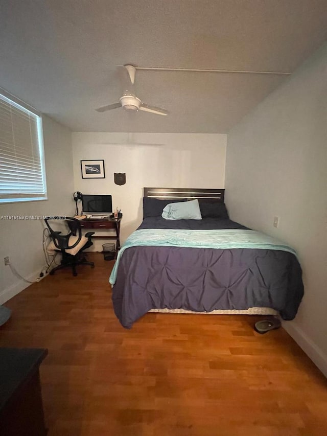 bedroom with ceiling fan and hardwood / wood-style floors