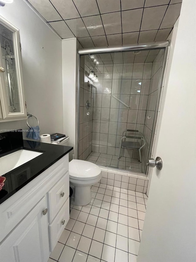 bathroom with vanity, an enclosed shower, tile patterned flooring, and toilet