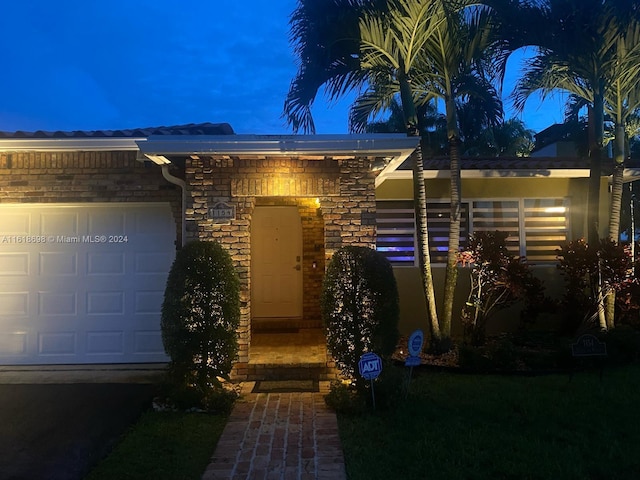 1154 Jefferson St, Hollywood, FL 33019 - view of front of home with a garage and stone siding