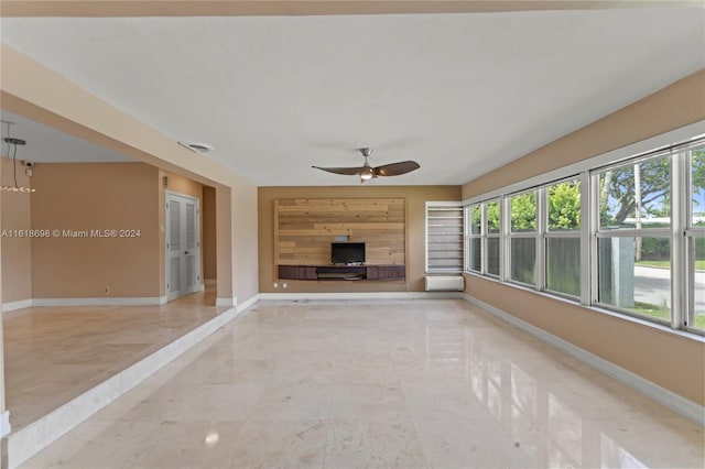 unfurnished living room with ceiling fan