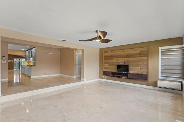 unfurnished living room featuring ceiling fan