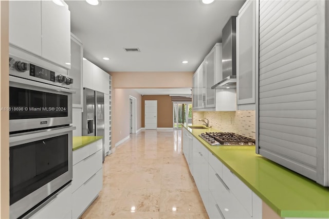 1154 Jefferson St, Hollywood, FL 33019 - kitchen featuring recessed lighting, stainless steel appliances, visible vents, decorative backsplash, and white cabinetry