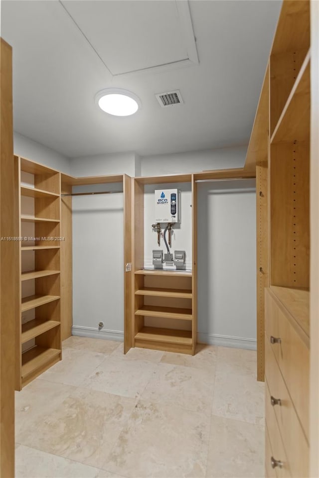 walk in closet featuring water heater