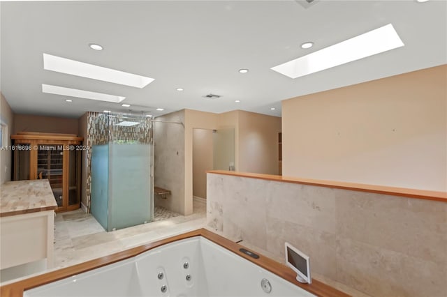 bathroom with shower with separate bathtub and a skylight