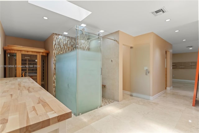 1154 Jefferson St, Hollywood, FL 33019 - bathroom featuring a skylight, visible vents, recessed lighting, and a stall shower