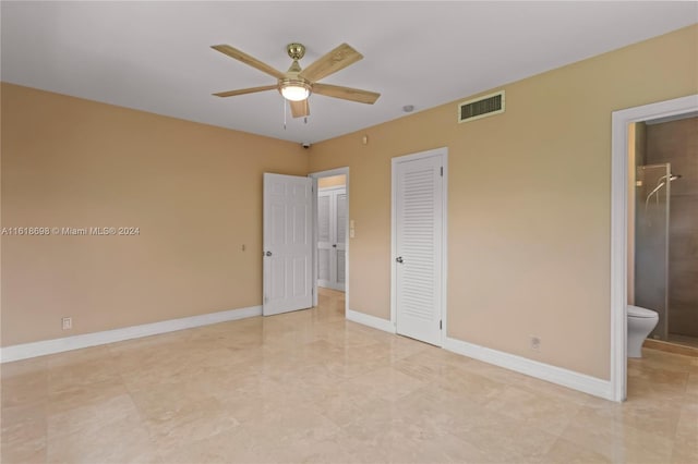 unfurnished bedroom featuring ceiling fan and ensuite bathroom