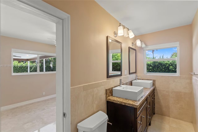 bathroom featuring tile walls, tile patterned flooring, vanity, and toilet