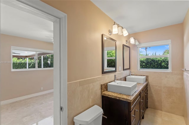 1154 Jefferson St, Hollywood, FL 33019 - bathroom featuring tile patterned floors, a sink, double vanity, and tile walls