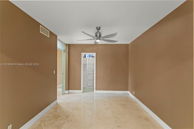 spare room featuring ceiling fan and concrete flooring