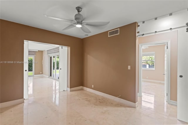 1154 Jefferson St, Hollywood, FL 33019 - empty room with ceiling fan, baseboards, a barn door, and visible vents