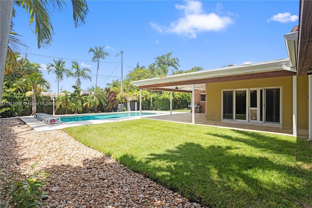 view of yard with a fenced in pool and a patio area