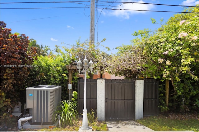 1154 Jefferson St, Hollywood, FL 33019 - view of gate featuring central AC unit