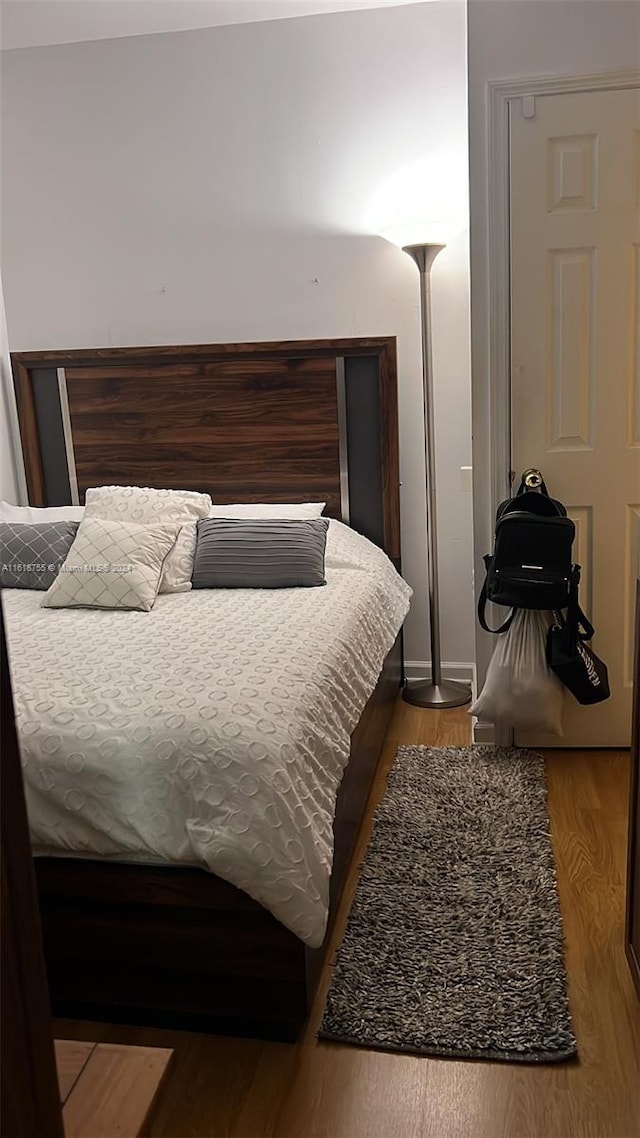 bedroom with hardwood / wood-style floors