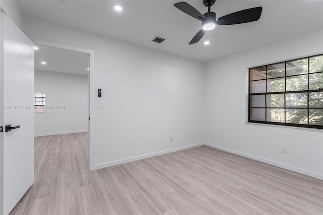 spare room with ceiling fan and light hardwood / wood-style floors