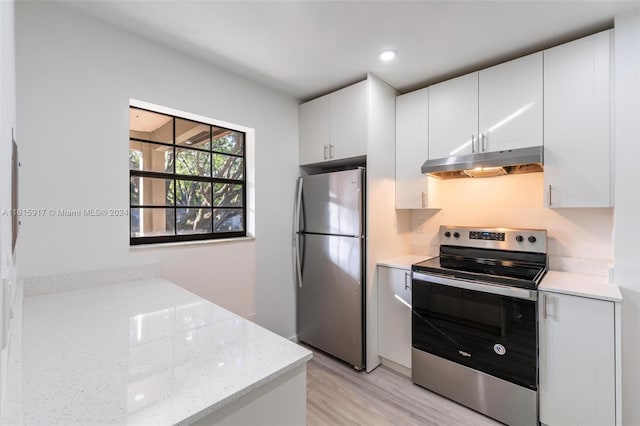 kitchen featuring light stone counters, stainless steel appliances, light hardwood / wood-style floors, and white cabinetry