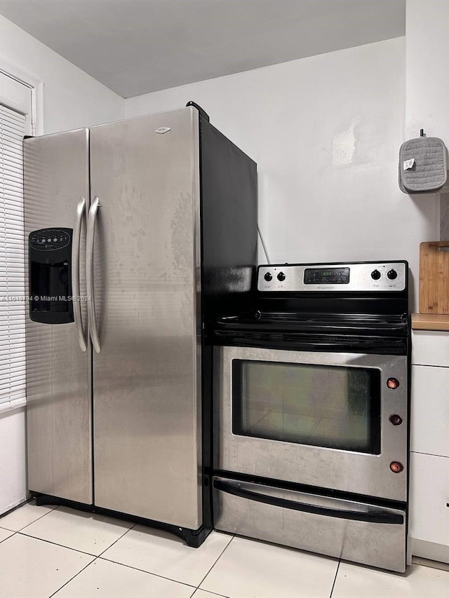 kitchen with light tile patterned floors and appliances with stainless steel finishes