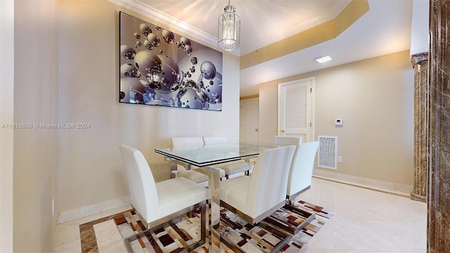 tiled dining space with visible vents, ornamental molding, and baseboards