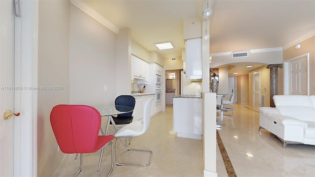 interior space featuring ornamental molding and sink