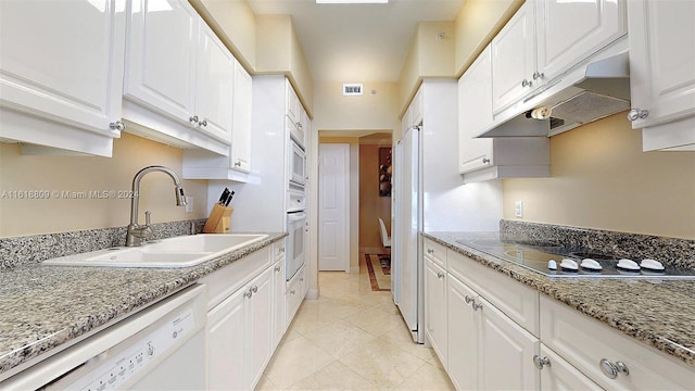kitchen featuring white cabinets, a sink, white appliances, under cabinet range hood, and visible vents