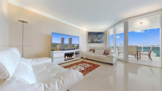 living room featuring crown molding, a lit fireplace, and a wall of windows
