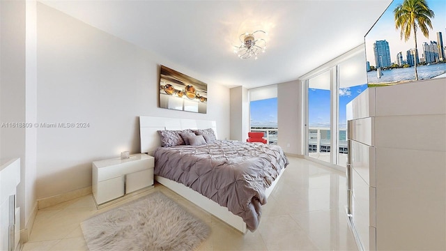 bedroom with tile patterned flooring, baseboards, and access to exterior