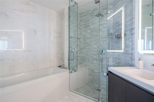 bathroom featuring vanity and shower with separate bathtub