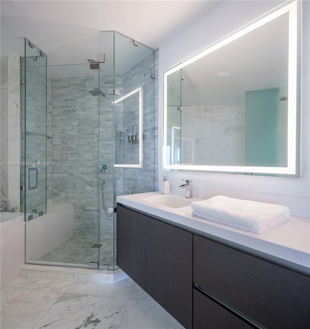 bathroom with vanity and a shower with door