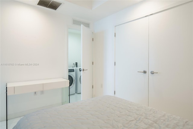 bedroom with washer and dryer and a closet