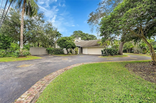 obstructed view of property with a front lawn