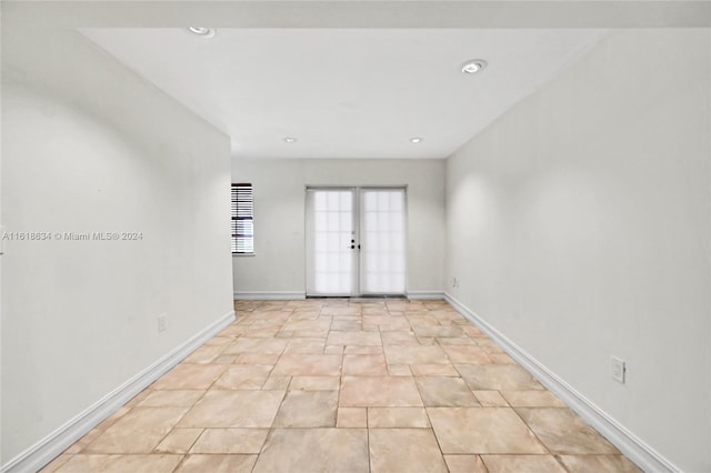 unfurnished room featuring french doors