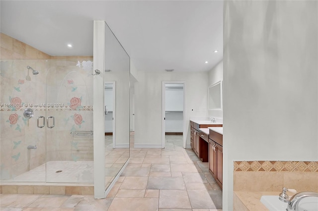 bathroom featuring shower with separate bathtub, vanity, and tile patterned floors