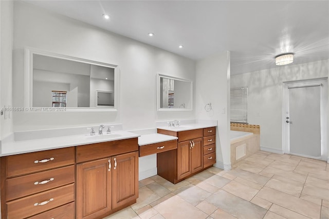 bathroom featuring tile patterned flooring, a bathtub, and vanity