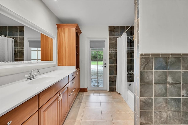 bathroom featuring vanity, tile patterned floors, tile walls, and shower / bath combo with shower curtain