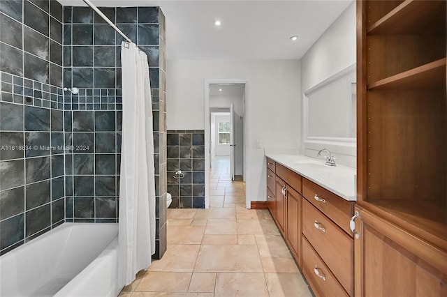 full bathroom featuring shower / bath combination with curtain, tile patterned floors, vanity, tile walls, and toilet