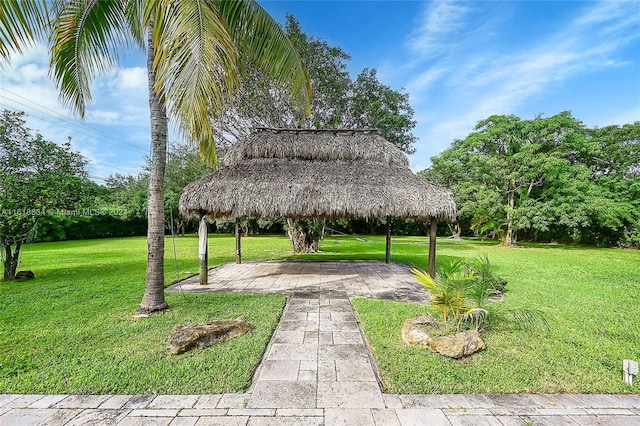 view of home's community with a gazebo, a patio area, and a lawn