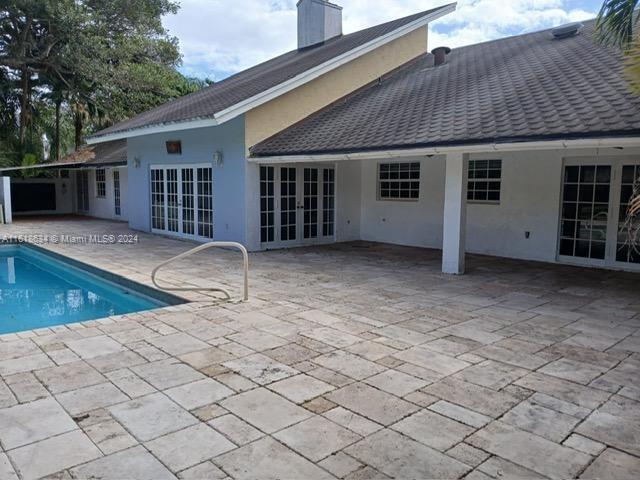 rear view of property with french doors and a patio area