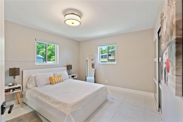 tiled bedroom featuring multiple windows