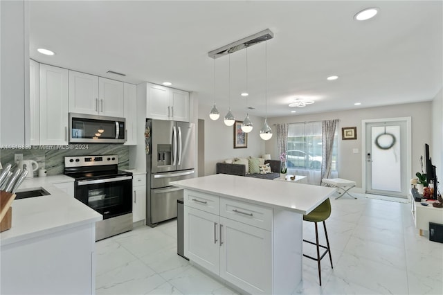 kitchen with white cabinetry, tasteful backsplash, light tile patterned floors, appliances with stainless steel finishes, and sink