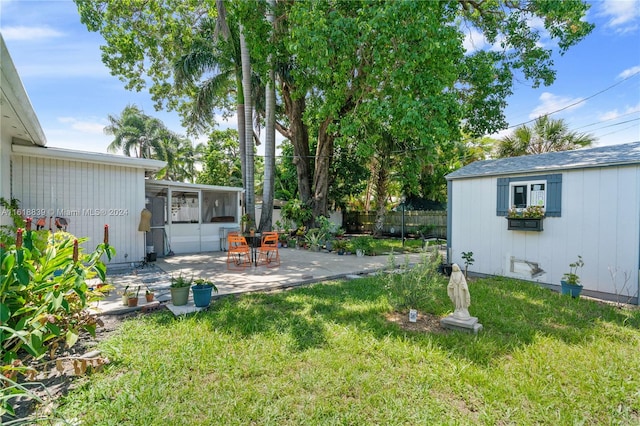 view of yard featuring a patio area and an outbuilding