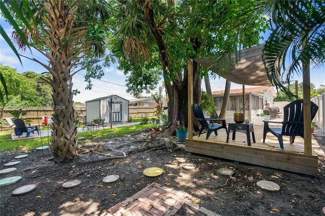 view of yard with a storage unit and a wooden deck