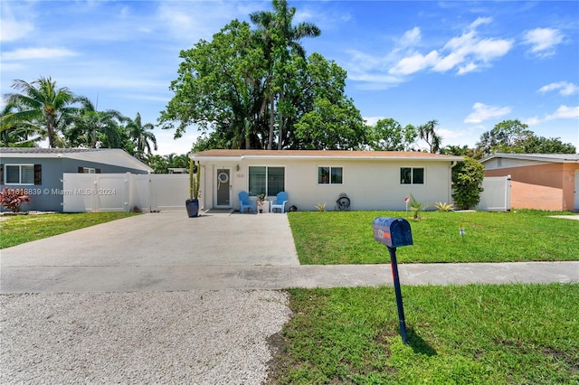 ranch-style home featuring a front yard