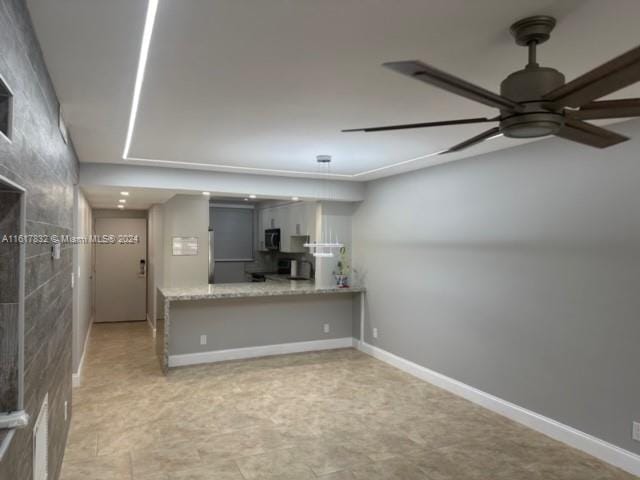 interior space with ceiling fan